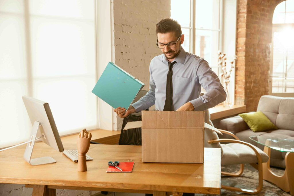 A young businessman moving in office, getting new work place