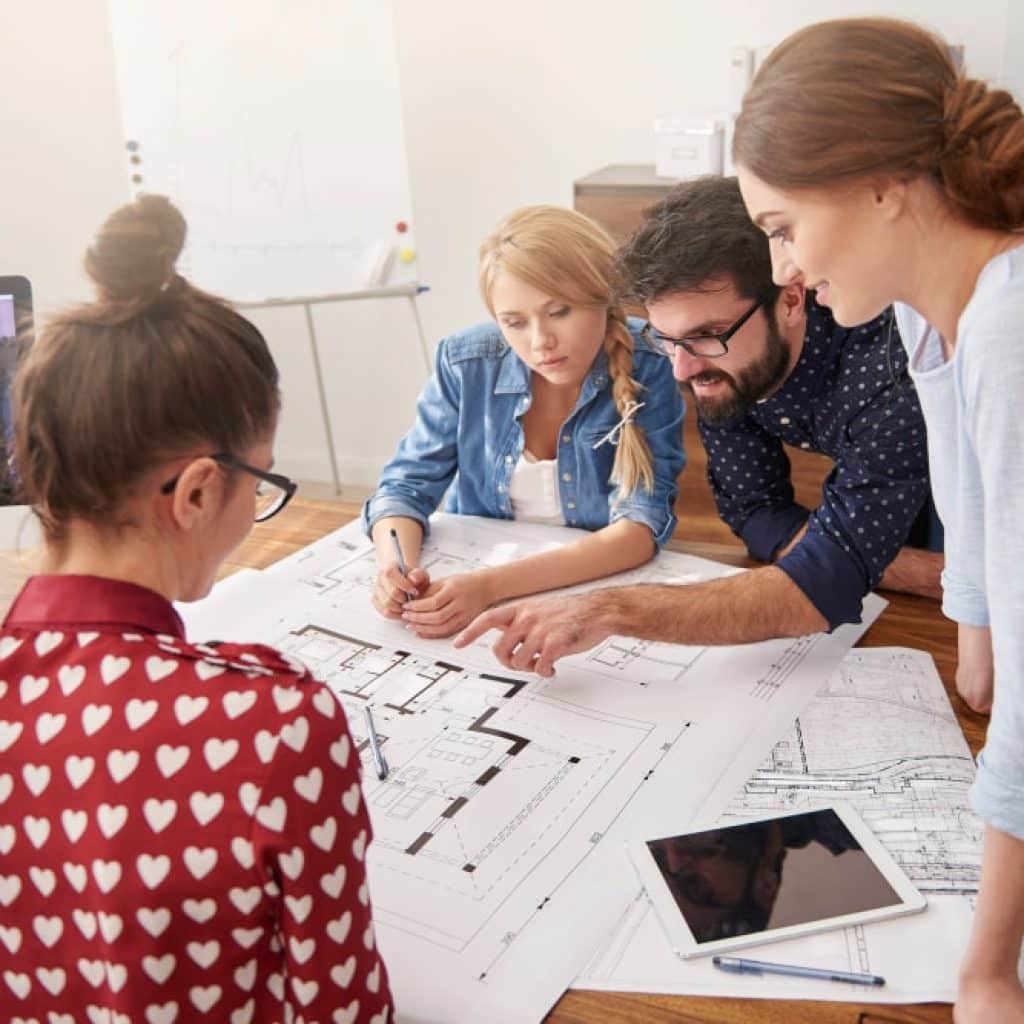 A layout plan for a new office space being discussed by a team.