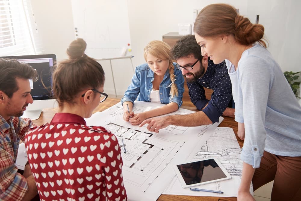 A layout plan for a new office space being discussed by a team.