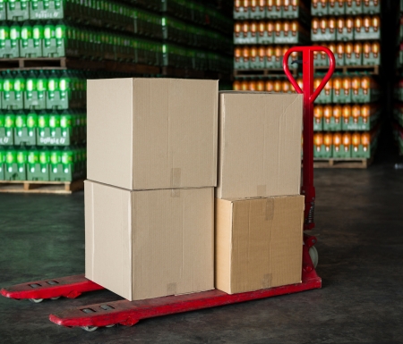 Cardboard boxes on trolley in juice factory