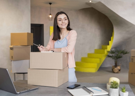 front view smiling woman preparing boxes delivery