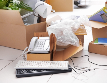 Move concept. Unpacking cardboard boxes in a new office